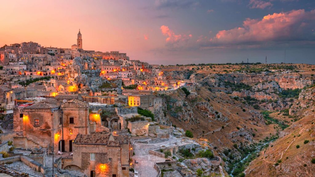 Panoramic view of Matera, Italy, showcasing the unique cave dwellings and historic architecture carved into the limestone cliffs.