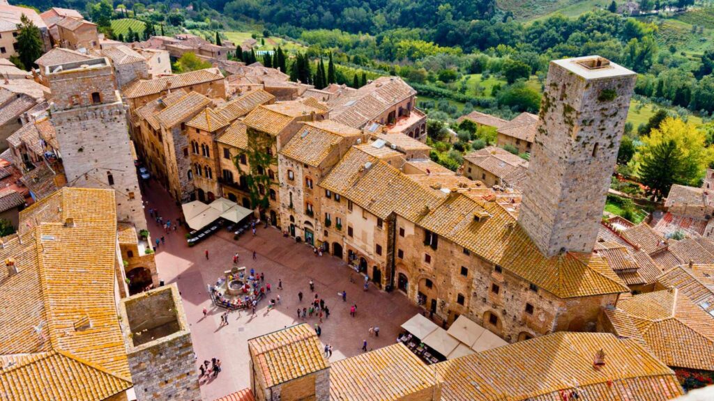 Panoramic view of San Gimignano, Tuscany, Italy, featuring its iconic medieval towers and picturesque landscapes.