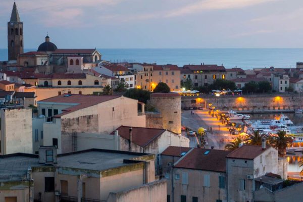Scenic view of Alghero, Sardinia, Italy, featuring historic architecture, the vibrant seafront, and the charming atmosphere of this coastal town.