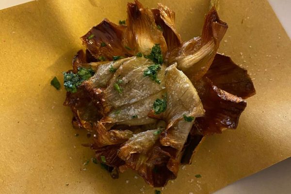 Close-up of delicious fried artichoke Roman style, showcasing its golden and crispy exterior with a mouthwatering aroma.