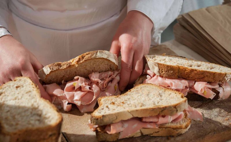 Delicious mortadella sandwich, featuring layers of savory mortadella, fresh greens, and artisanal bread.
