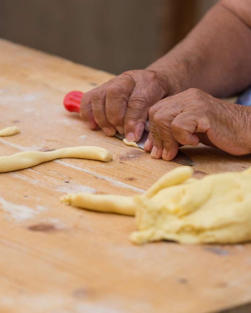 Bari's Orecchiette artisan preparing the dough for the traditional pasta, showcasing the hands-on craftsmanship of creating these ear-shaped delights.