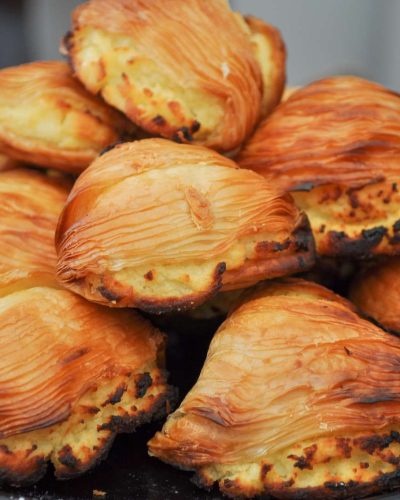 Close-up of delicious Sfogliatelle Napoletane, a traditional Neapolitan pastry, showcasing its flaky layers and sweet ricotta filling.