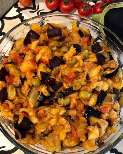Close-up of Sicilian Caponata, a traditional eggplant dish with olives, tomatoes, and capers, showcasing its rich colors and savory flavors.