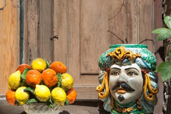 Collection of colorful souvenirs from Sicily, Italy including ceramics, showcasing the island's vibrant cultural heritage.